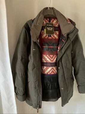 Burton Olive Green Heavy 
Jacket with Red Patterned Lining. Excellent condition